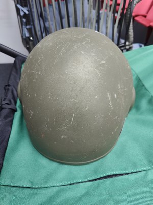 Lot 104 - Military helmet in traditional green
