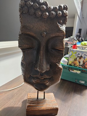 Lot 80 - Decorative statue of face on stand