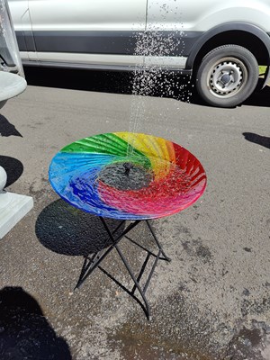 Lot 118 - Rainbow coloured solar powered bird bath fountain with small side table