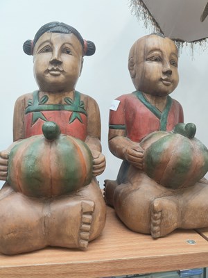 Lot 78 - Pair of wooden children holding gifts