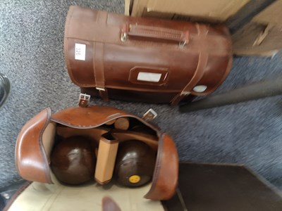 Lot 326 - 2 leather bags containing lawn bowls