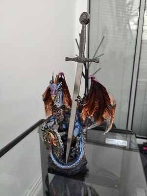 Lot 160 - Dragon statue holding sword