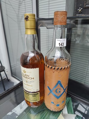 Lot 143 - Glass decanter with leather wrap bearing masonic symbols and a bottle of glen march whisky (leaking)