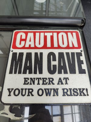Lot 215 - Cast metal man cave square sign