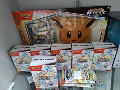 Lot 82 - Pokémon prismatic eevee pouch set with booster bundle opened