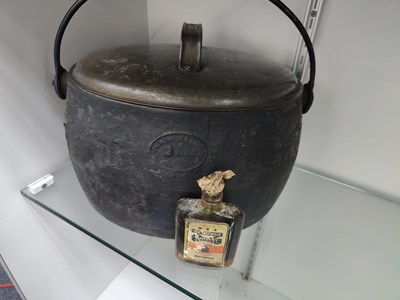 Lot 68 - Vintage Large 2 gallon cast iron pot with lid, 2 empty tins and bottle of old bush mills whiskey (not recommended for consumption)