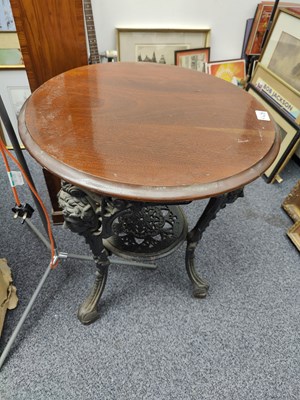 Lot 153 - Cast table base with decorative features and round hardwood top