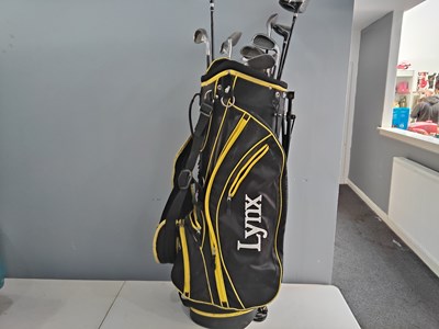 Lot 228 - Lynx golf bag with selection of clubs