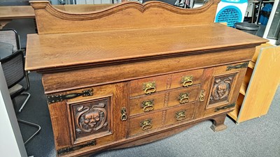 Lot 297 - Heavy oak sideboard with carved lion door and metal handles