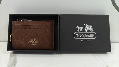 Lot 100 - Leather wallet / purse bearing coach logos