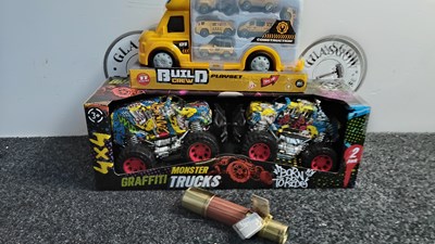 Lot 182 - Three Kids Toys, Including Graffiti Monster Trucks, Build Crew Vehicle Transporter Set & Adventure Telescope - New