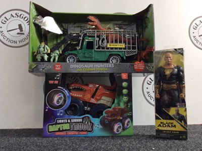 Lot 54 - Three Kids Toy, Including Dinosaur Hunters All Terrain Vehicle, Musical Raptor Truck & Black Adam Figurine - New