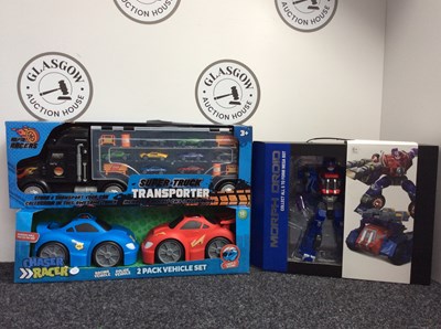 Lot 129 - Three Kids Toys, Including Morph Droid Bot, Chase Racer 2 Pack Vehicle Set & Super Truck Transporter - New