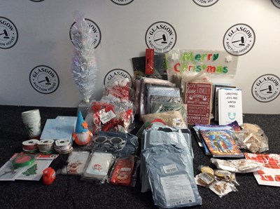 Lot 35 - Large Qty Of Christmas Items Including Wall Plaques, Children’s Christmas Stories, Large Flags/ Prints, Headwear, Phone Cases, A Mini Light Up Tree 2FT & More - Mixed