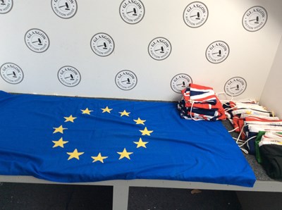 Lot 27 - Large box containing fabric flags from various countries