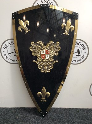 Lot 52 - Black and gold small kite shield with decorative crest
