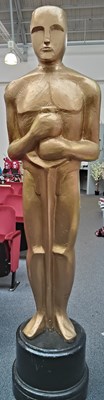 Lot 40 - Tall prop decorative oscar style statue in gold finish with black base
