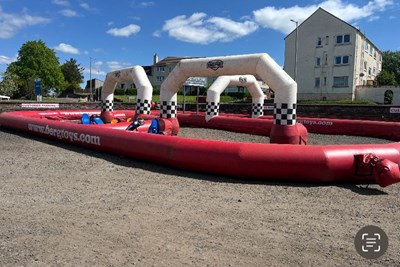 Lot 124 - Inflatable go cart track with 4 kids and 5 adult pedal carts