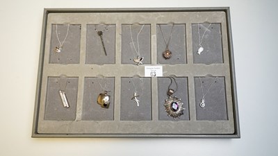 Lot 63 - 10 silver necklaces on display board