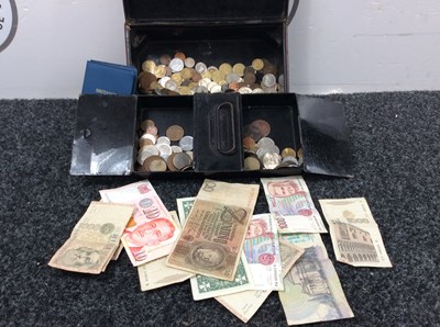 Lot 146 - Tin with coins and notes in it..