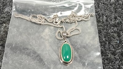 Lot 135 - Silver stamped chain and pendant featuring green onyx/chrysoprase stone