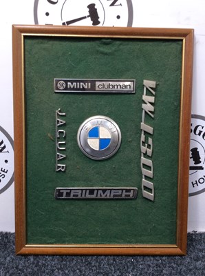 Lot 111 - Framed vehicle badges of green felt background