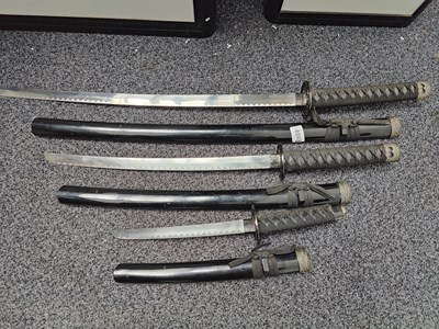 Lot 172 - Three black samurai swords in sheaths