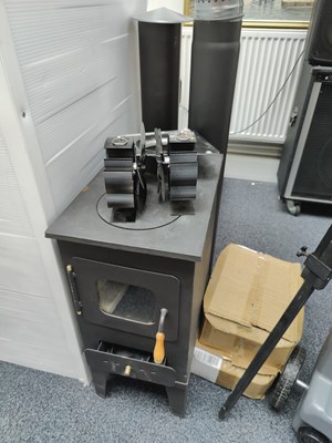 Lot 145 - Cast iron stove with all accessories required Inc vents, fans and bricks