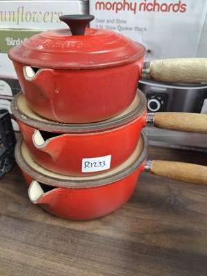 Lot 7 - Three Le Creuset red pots
