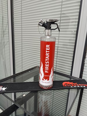 Lot 131 - Fire starter vodka in novelty bottle with rubber bar mat